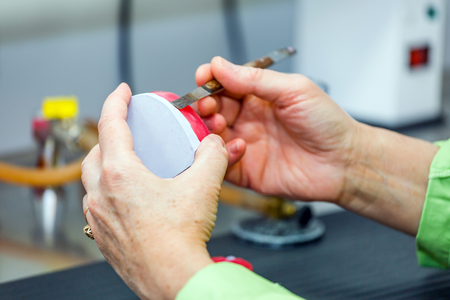 Dental technician working on impression in dental laboratoryの写真素材