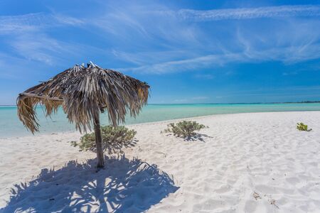 Beach Umbrella made of palm leafs on the background of an exotic beach in Cayo Largoの写真素材