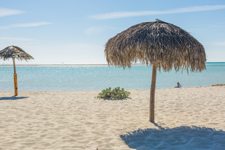 Beach Umbrella made of palm leafs on the background of an exotic beach in Cayo Largoの写真素材