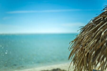 Beach Umbrella made of palm leafs on the background of an exotic beach in Cayo Largoの写真素材