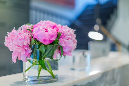Interiors of a office medical reception with beautiful pink flowers in vaseの写真素材