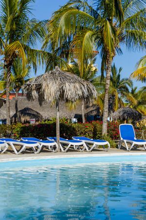 Pool with sun chairs and palm trees in an all inclusive hotel. Cayo Largoの写真素材