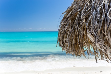 Beach Umbrella made of palm leafs on the background of an exotic beach in Cayo Largoの写真素材