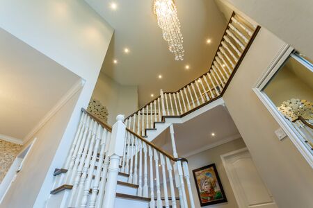 Beautiful foyer looking down hardwood stairs in new houseの写真素材