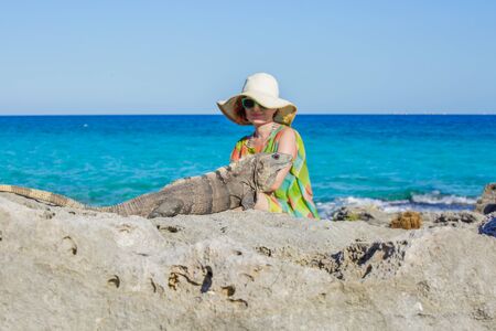 Women and iguanaの写真素材