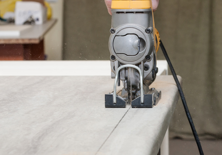 electrofret cut the kitchen countertop for installation of kitchen equipmentの写真素材