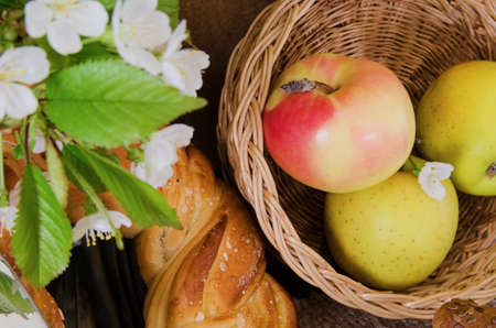 apples in a wicker basket, pastries, fruit and flowersの写真素材