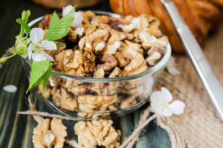 peeled walnuts in a glass bowl close-upの写真素材