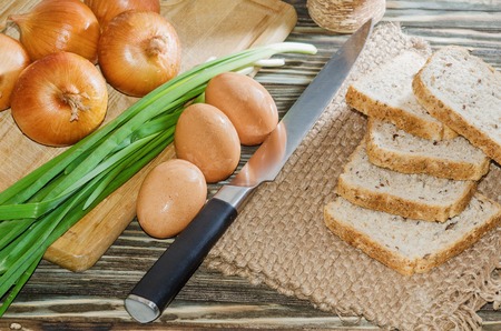 Eggs, bread, cereal and other vegetables on wooden background close-upの写真素材