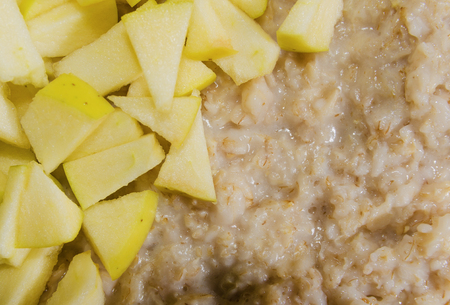 ready oatmeal with sliced apple closeup thorough inspectionの写真素材