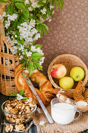 cup of milk with fresh pastries and nuts close-upの写真素材