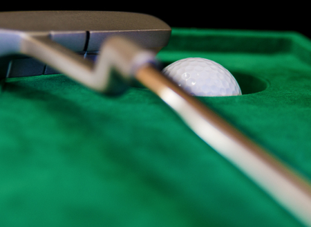 indoor mini golf, ball pocket and putter on green clothの写真素材