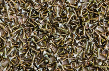 Background from a variety of yellow screws closeupの写真素材