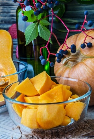Pumpkin and pumpkin jam, puree or sauce on green with white tablecloth. Autumn still life.の写真素材