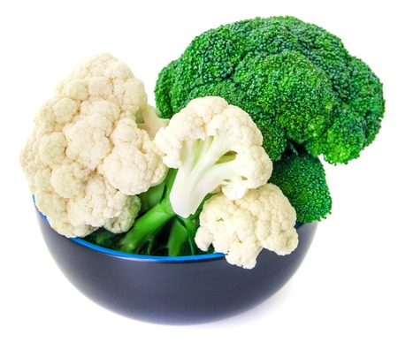 Cauliflower, broccoli, carrots and beans on a plate. Isolated on white.の写真素材