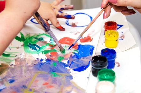 Mom teaches a young child paints risoaniyuの写真素材
