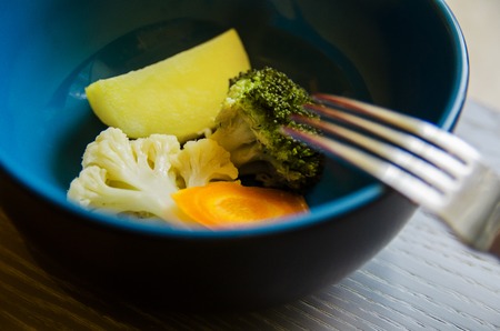 broccoli, cauliflower and other frozen vegetables on a wooden backgroundの写真素材