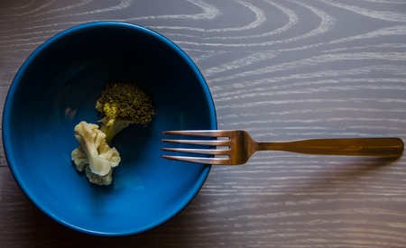 broccoli, cauliflower and other frozen vegetables on a wooden backgroundの写真素材