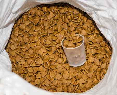 pet food in a bag with a measured glass closeupの写真素材