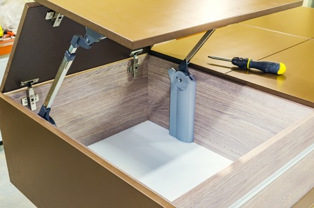Assembling of furniture, installation of the lifting mechanism on the furniture bodyの写真素材