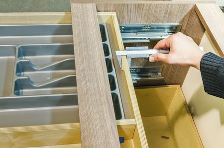 Assembling the kitchen drawer with a tray for the spoons and forksの写真素材