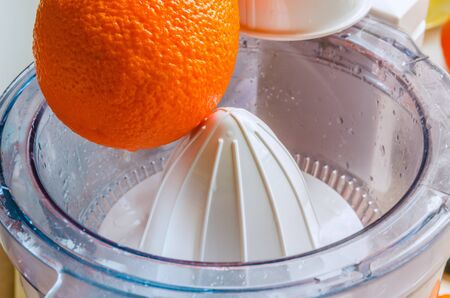 Preparation of orange juice with a juicerの写真素材