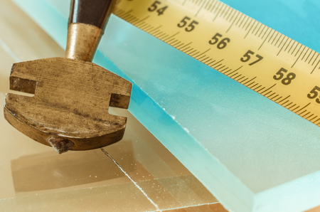 glass and glass cutter closeup on wooden backgroundの写真素材
