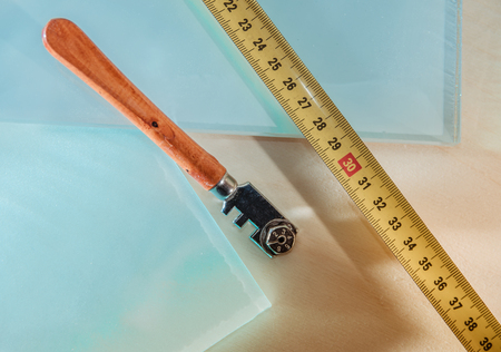 glass and glass cutter closeup on wooden backgroundの写真素材