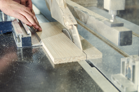 Production of cabinet furniture, sawing, materials on a format-cutting machineの写真素材