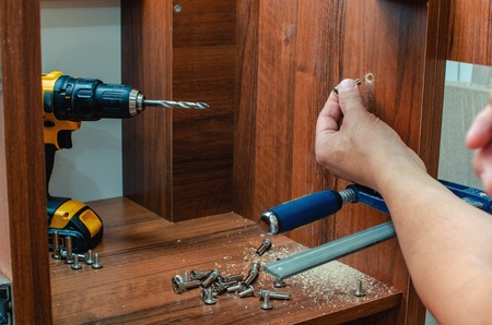 Furniture canopies can be screwed with screws to the closet door, close-upの写真素材