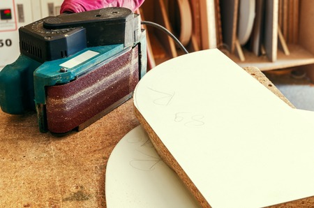 Employee workpieces for furniture hand router closeupの写真素材