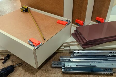 Wooden furniture with drawers and glossy white MDF facadesの写真素材