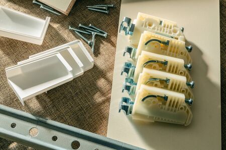 Furniture fittings, cabinet holder for kitchen hanging cabinets and mounting plate in a furniture workshopの写真素材