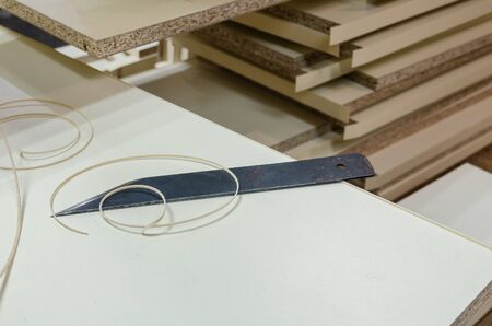 The carpenter processes the blanks for the manufacture of furniture. Splitting PVC endsの写真素材