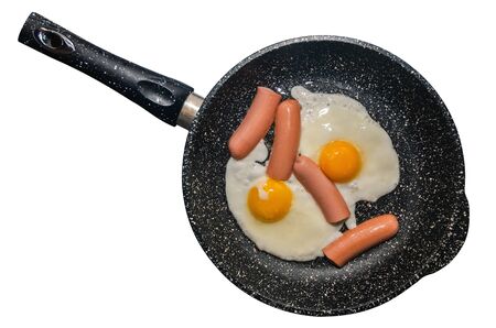 Breakfast, fried eggs in a pan with sausages, closeup isolated on white backgroundの写真素材