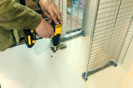 Installation of a furniture canopy on a furniture facade, close-up