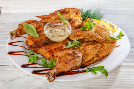 baked grilled chicken with garlic sauce, herbs and lemonの写真素材
