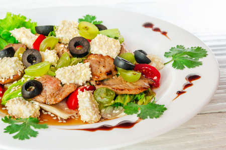 Summer vegetable salad on a white dish on a woodenの写真素材