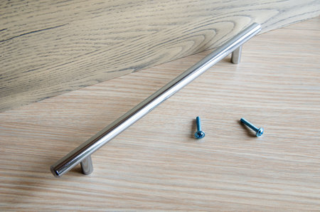 Assembling furniture, installing furniture decorative handles on the furniture facadeの写真素材