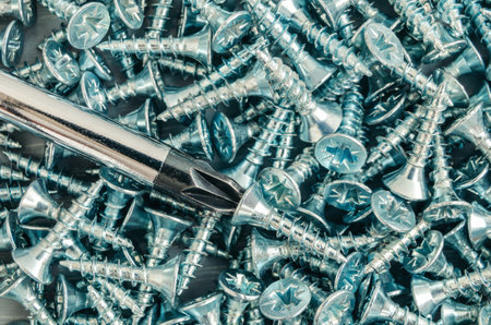 Chrome furniture screws close up on wooden background, overhaulの写真素材