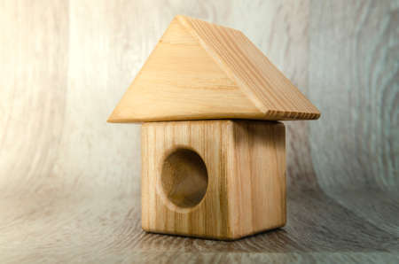 Small house figurine made of wood, real estate concept.の写真素材