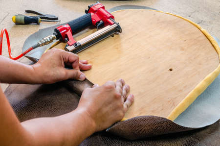 manufacture of upholstered furniture, furniture upholstery with a pneumatic staplerの写真素材