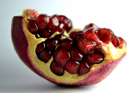 half of pomegranate isolated on a white background, close upの写真素材