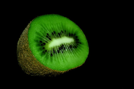 kiwi fruit isolated on a black backgroundの写真素材
