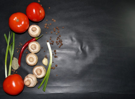 vegetables: red tomatoes, mushrooms, garlic, red hot pepper, green onions and spice. Top view. Space...
