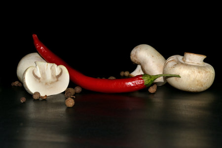 cutted mushroom, red hot pepper on black backgroundの写真素材