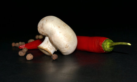 mushroom, red hot pepper and allspice on black backgroundの写真素材