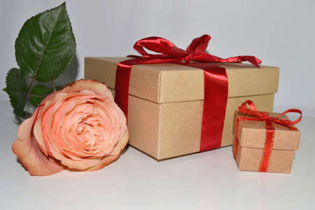 gift boxes with red ribbon and pink rose isolated on white backgroundの写真素材