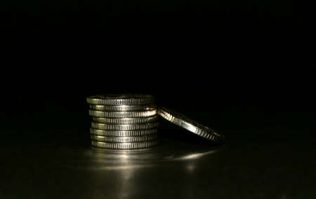 silver coin stack isolated on black background. Space for textの写真素材