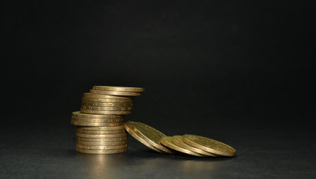 Stack of coins isolated on a dark backgroundの写真素材